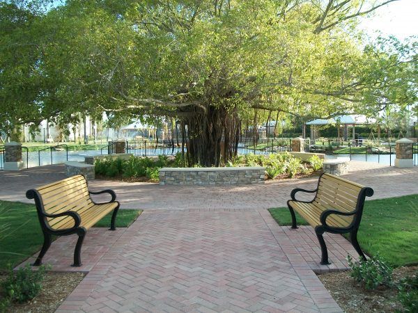 Park with greenery and two benches facing each other
