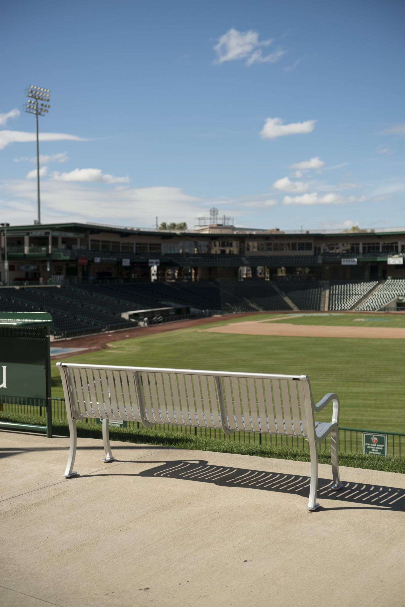 Silver bench overlooking baseball field