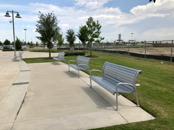Silver benches outside of a park